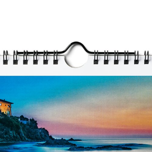 Paper wall calendar with spiral binding for hanging.
